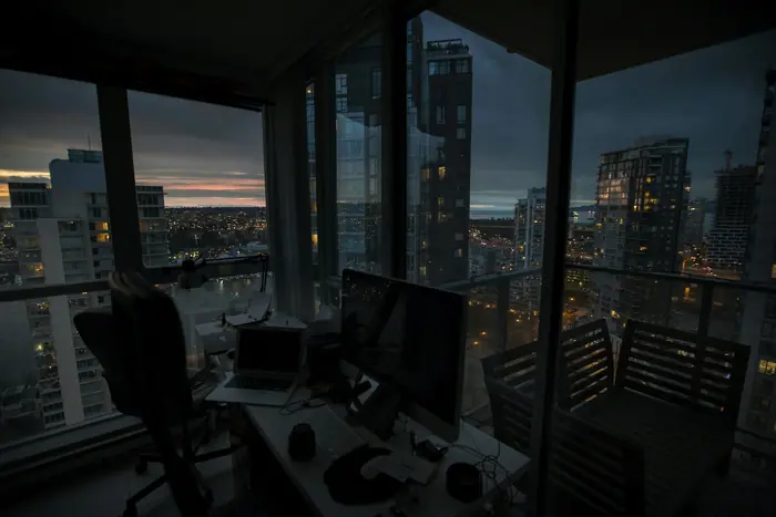 Merchant at a desk beside a window at dusk
